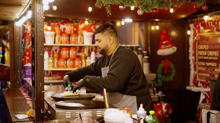 Baking Crepes at a Christmas Market - LONDON, UK - DECEMBER 20, 2022のeditorial素材