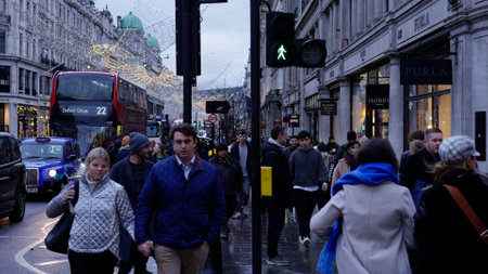 People walking through Regent Street in London at Christmas time - LONDON, UK - DECEMBER 20, 2022のeditorial素材