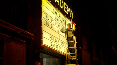 Man changes the letters on a theater billboard - DUBLIN, IRELAND - APRIL 20, 2022のeditorial素材