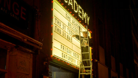 Man changes the letters on a theater billboard - DUBLIN, IRELAND - APRIL 20, 2022のeditorial素材