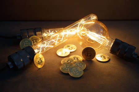 BTC among avid bulbs. The light flashes, an electrical short circuit. Closeup, Shallow depth of fields.の写真素材