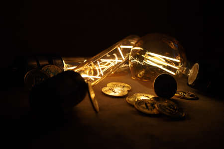 BTC among avid bulbs. The light flashes, an electrical short circuit. Closeup, Shallow depth of fields.の写真素材