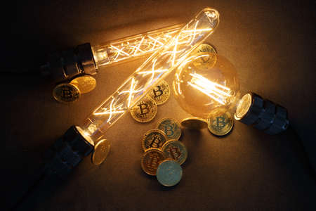 BTC among avid bulbs. The light flashes, an electrical short circuit. Closeup, Shallow depth of fields.の写真素材