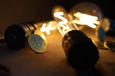 BTC among avid bulbs. The light flashes, an electrical short circuit. Closeup, Shallow depth of fields.の写真素材