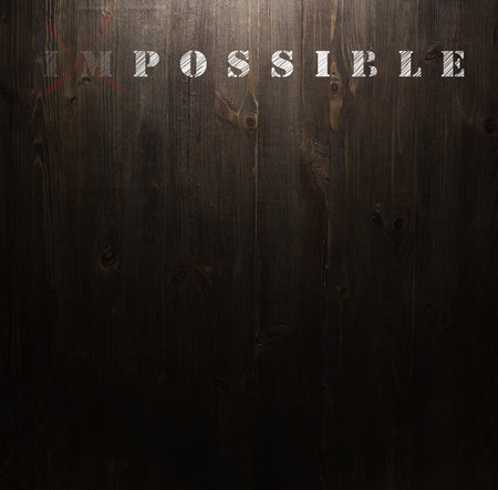 impossible text on wooden wallの写真素材