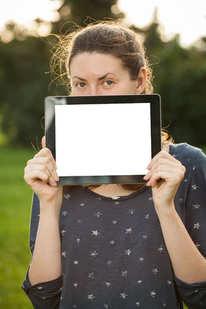 Young woman using tablet outdoorの写真素材