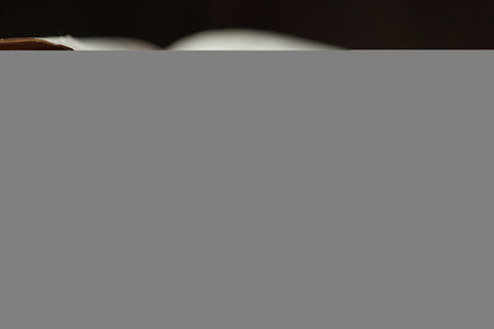 Image of an old Holy Bible on wooden background in a dark space