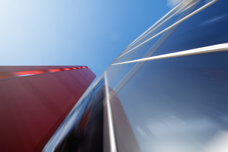 Wide angle abstract background view of steel light blue high rise commercial building skyscraper made of glass exterior. concept of successful industrial architecture and office center buildingの写真素材