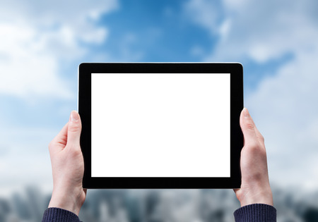 Hands holding tablet with Business center on the backgroundの写真素材