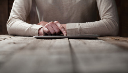 woman shows screen of digital tablet in her hands
