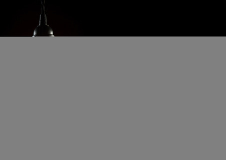 A classic Edison light bulb on black background with space for textの写真素材