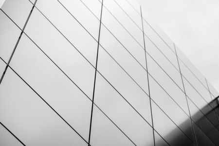Wide angle abstract background view of steel light blue high rise commercial building skyscraper made of glass exterior. concept of successful industrial architecture and office center buildingの写真素材