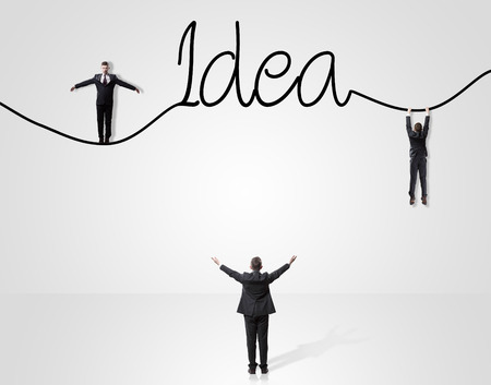 businessmen standing on ladder and drawing idea conceptの写真素材