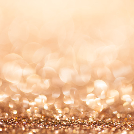 Gold defocused glitter background with copy spaceの写真素材