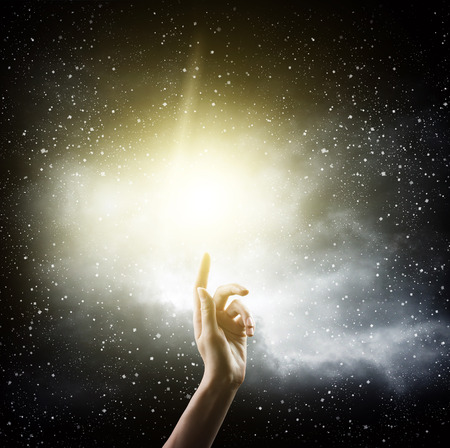 religion concept. finger touching the magic skyの写真素材