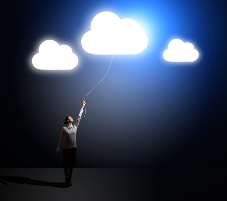 businesswoman holding a flying cloud. idea conceptの写真素材