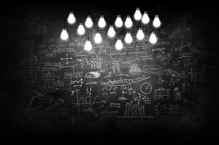 lit bulb with drawn formula in classの写真素材