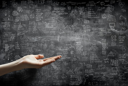 hand holding or showing something in front of  business idea concept on wall backboard blackgroundの写真素材