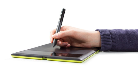 isolated womans hand draws a pen on a touch tabletの写真素材