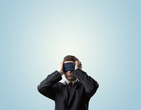 businessman with a bandage on his eyesの写真素材