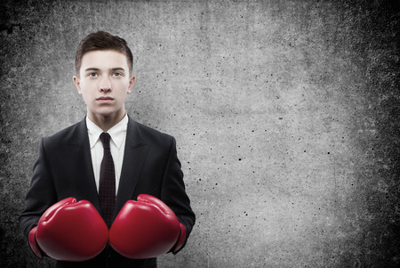 businessman in boxing gloves on backgroundの写真素材