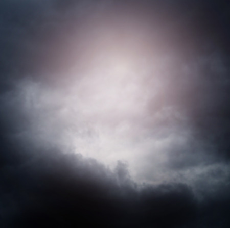 Hand reaching for the cloud in the sky