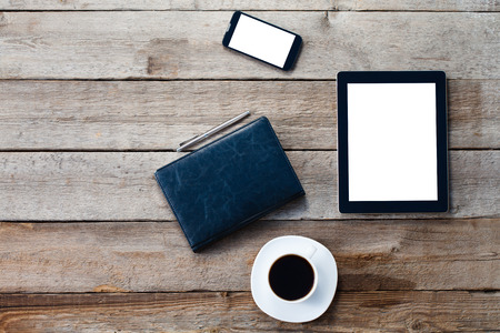 digital tablet computer with isolated screen over old grey wooden background table.の写真素材