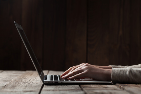 woman hands using laptop at office deskの写真素材