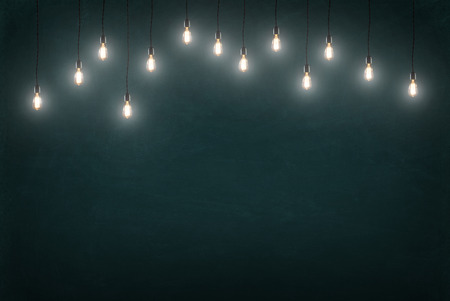 Light bulbs on dark chalkboard backgroundの写真素材