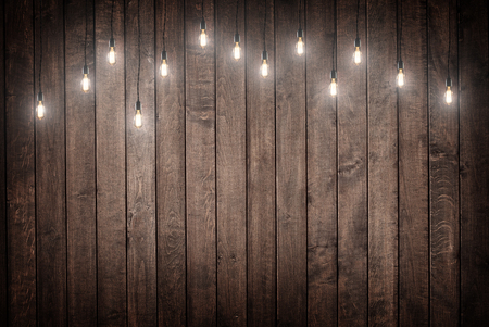 Light bulbs on dark Wooden Backgroundの写真素材