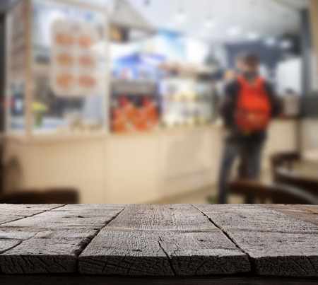 Coffee shop blurred background with bokeh and wooden floorの写真素材