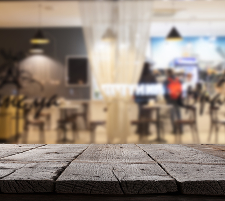 Coffee shop blurred background with bokeh and wooden floorの写真素材