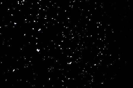 Snow on a black background for use as an overlay layerの写真素材