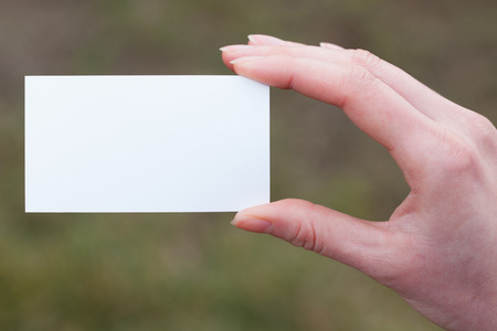 Hand holding a blank business or visit cardの写真素材