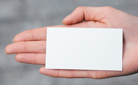Hand holding a blank business or visit cardの写真素材
