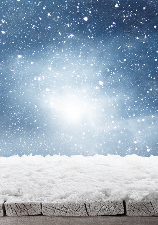 wooden board with snow flakes . Christmas backgroundの写真素材