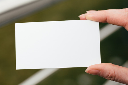 Hand holding a blank business or visit cardの写真素材
