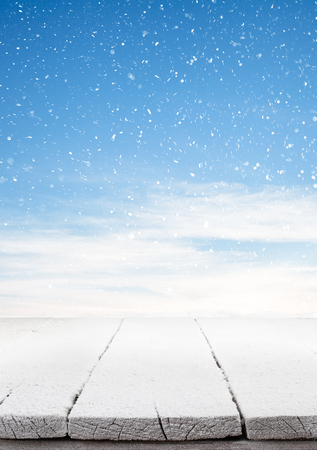 wooden board with snow flakes . Christmas backgroundの写真素材