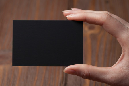 Hand holding a blank business or visit cardの写真素材