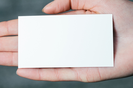 Hand holding a blank business or visit cardの写真素材