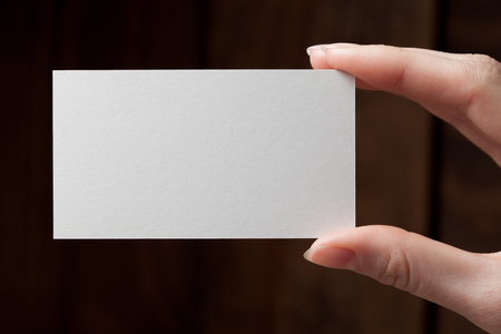 Hand holding a blank business or visit cardの写真素材