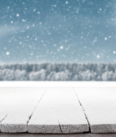 Blue Christmas background with trees and snow and wooden floorの写真素材