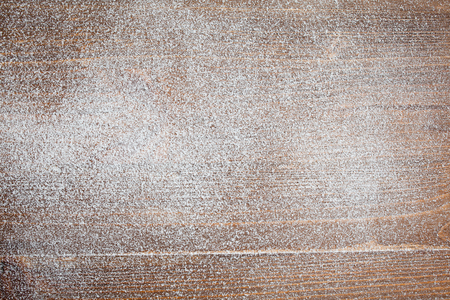 Christmas background with falling snow over wooden backgroundの写真素材