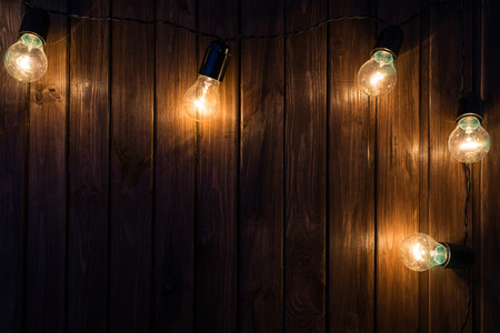 Light bulbs on dark Wooden Backgroundの写真素材