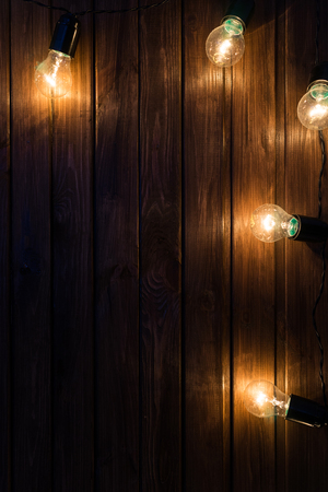Light bulbs on dark Wooden Backgroundの写真素材