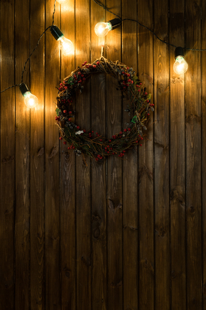 Light bulbs on dark wooden background and christmas decorの写真素材