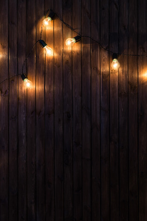 Light bulbs on dark Wooden Backgroundの写真素材