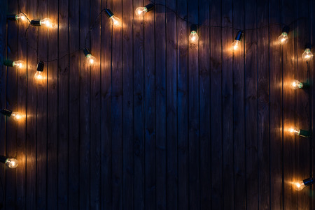 Light bulbs on dark Wooden Background real imageの写真素材