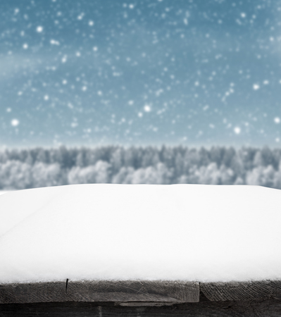 Blue winter background with trees and snowの写真素材