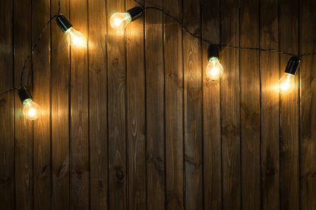 Light bulbs on dark Wooden Background real imageの写真素材
